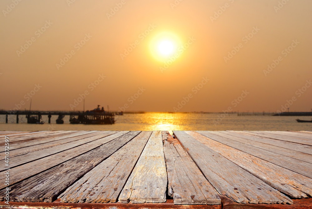 Wooden platform beside tropical sunset sea
