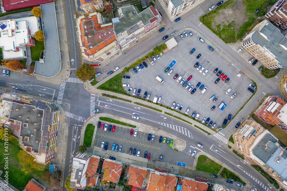 Aerial view from drone of a city road junction and car parking