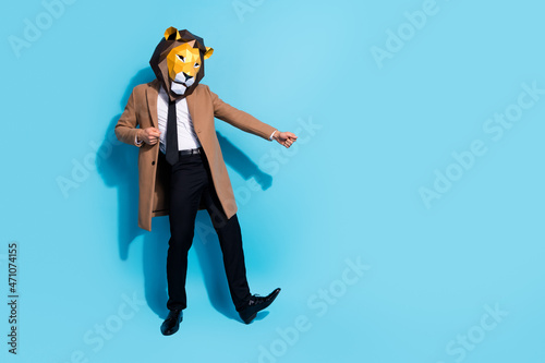 Full length photo of excited lion character guy dance theme festive event empty space isolated over blue color background