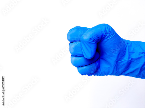 Hand in blue glove. Hand gesture, clenched fist. Isolated in white background. Space for text