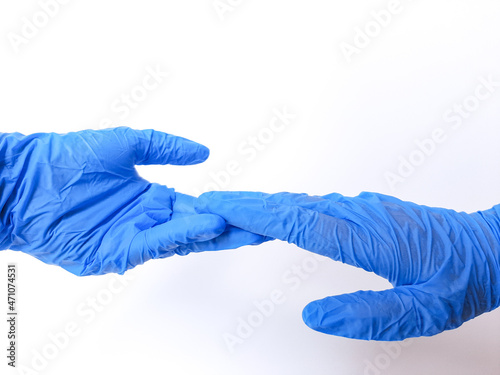 Two hands wearing blue glove, almost holding hands. Isolated in white background. Space for text