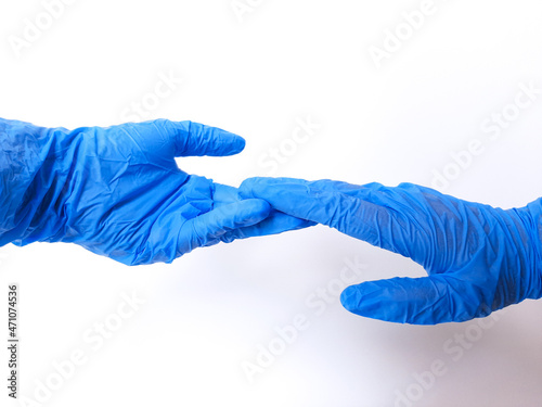 Two hands wearing blue glove, almost holding hands. Isolated in white background. Space for text