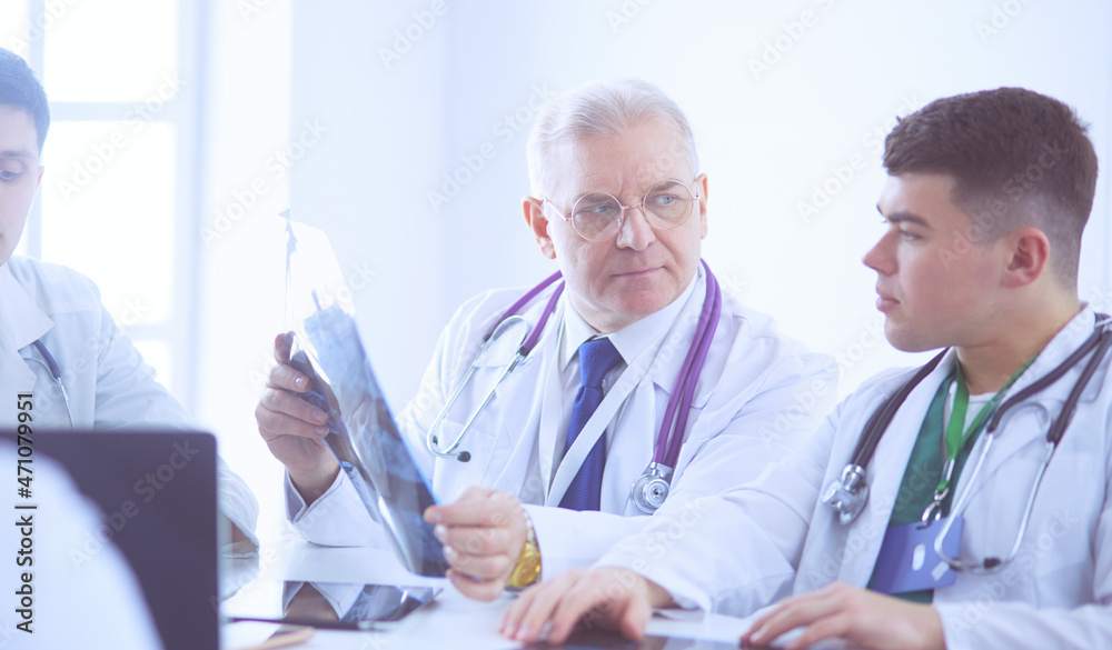 Medical team sitting and discussing at table Medical team sitting and discussing at table