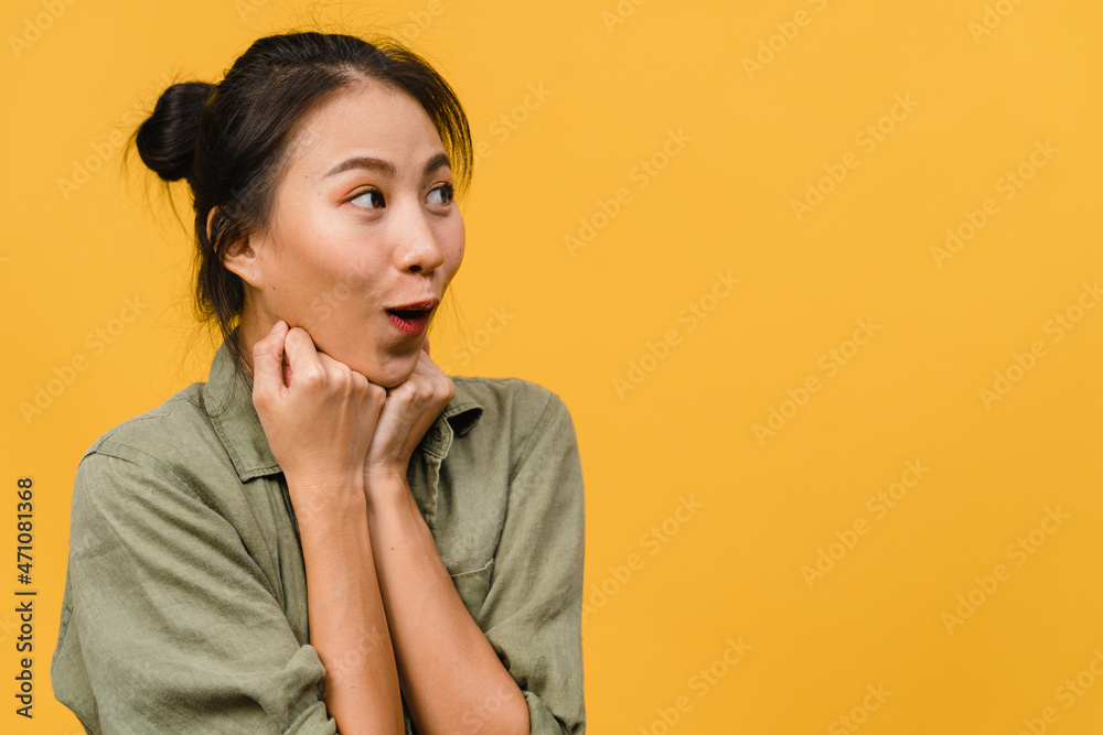 Young Asia lady feel happiness with positive expression, joyful surprise funky, dressed in casual cloth isolated on yellow background. Happy adorable glad woman rejoices success. Facial expression. Young Asia lady feel happiness with positive expression, joyful surprise funky, dressed in casual cloth isolated on yellow background. Happy adorable glad woman rejoices success. Facial expression.