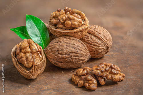 Walnuts on dark rustic background. Walnuts kernels with Copyspace. Nut healthy food concept. Closeup.