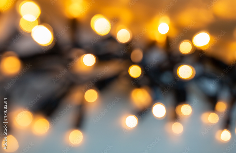 christmas, holidays and illumination concept - blurred electric garland lights