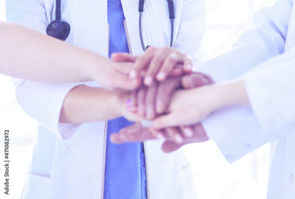 Group of doctors putting their hands together. Close-up Group of doctors putting their hands together. Close-up