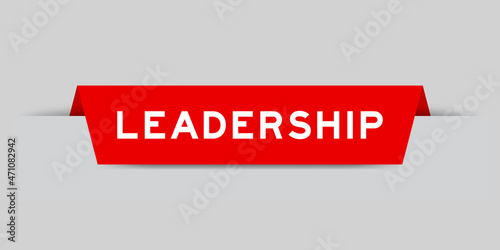Red color inserted label with word leadership on gray background