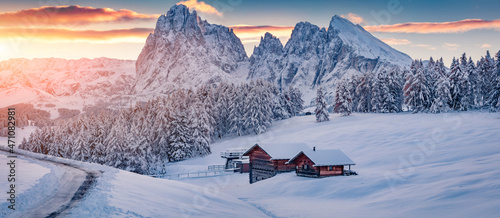 Christmas poster. Panoramic winter view of Alpe di Siusi village with Plattkofel peak on background. Amazing morning scene of Dolomite Alps. Stunning winter landscape of Ityaly, Europe.
