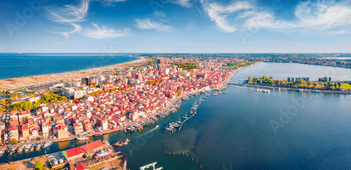 Fototapeta Naklejka Na Ścianę i Meble -  Astonishing summer view from flying drone of Sottomarina town. Aerial seascape of Adriatic sea. Captivating morning scene of Italy, Europe. Traveling concept background.