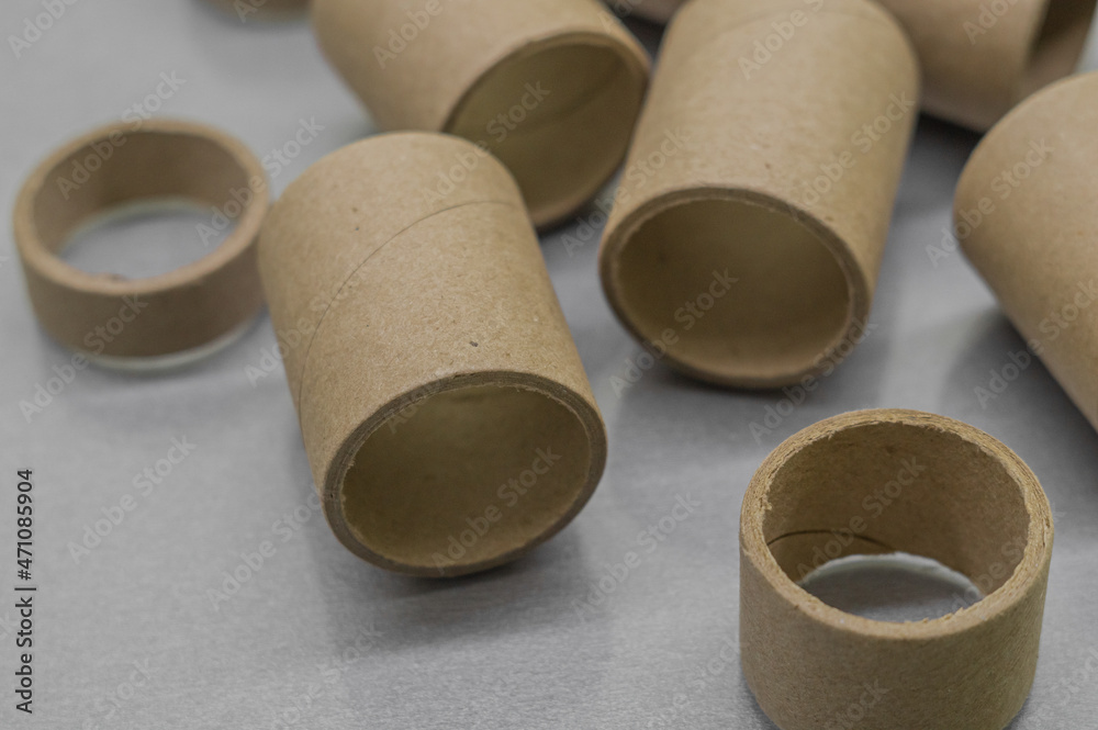 Cardboard spools for winding. Reels made of cardboard. Background of cardboard bobbins. Selective focus Cardboard spools for winding. Reels made of cardboard. Background of cardboard bobbins. Selective focus
