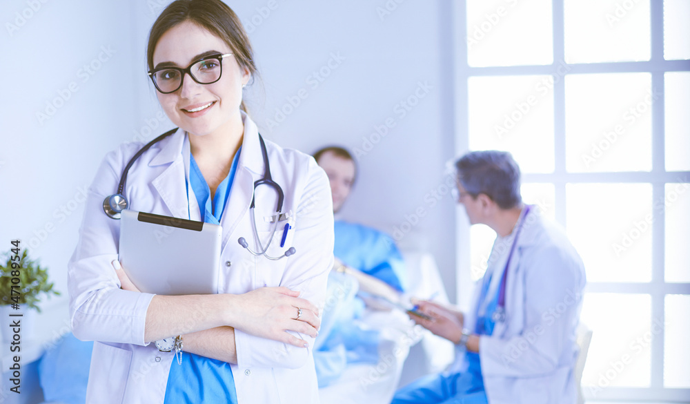 Fototapeta premium Female doctor using tablet computer in hospital lobby