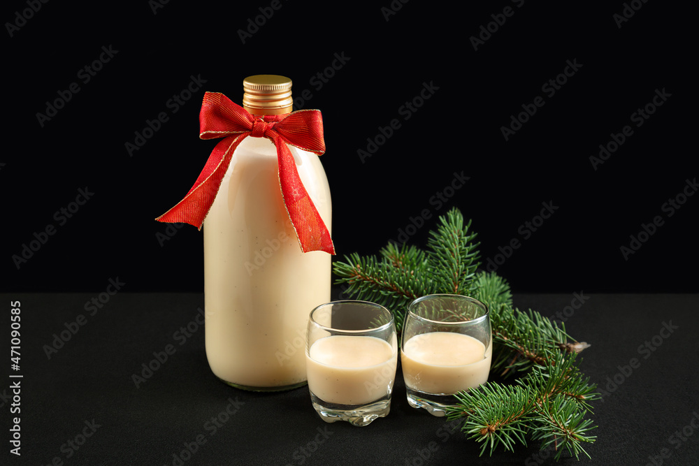 Homemade eggnog in bottle and two glasses with Christmas cookies Stock