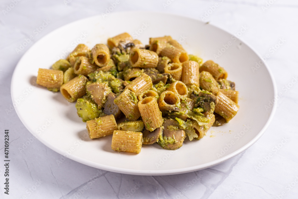 Pasta with mushrooms and broccoli cream. Ideal dish for a vegan diet. Pasta with mushrooms and broccoli cream. Ideal dish for a vegan diet.