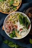 Delicious vietnamese beef noodles pho with ingredients.