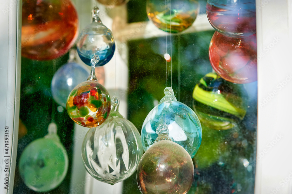 Multicolored glass balls in the window of a glass blowing workshop