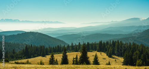 View from the side of Lake Belmeken to the Rila mountains and the peaks of the Pirin mountains in the fog