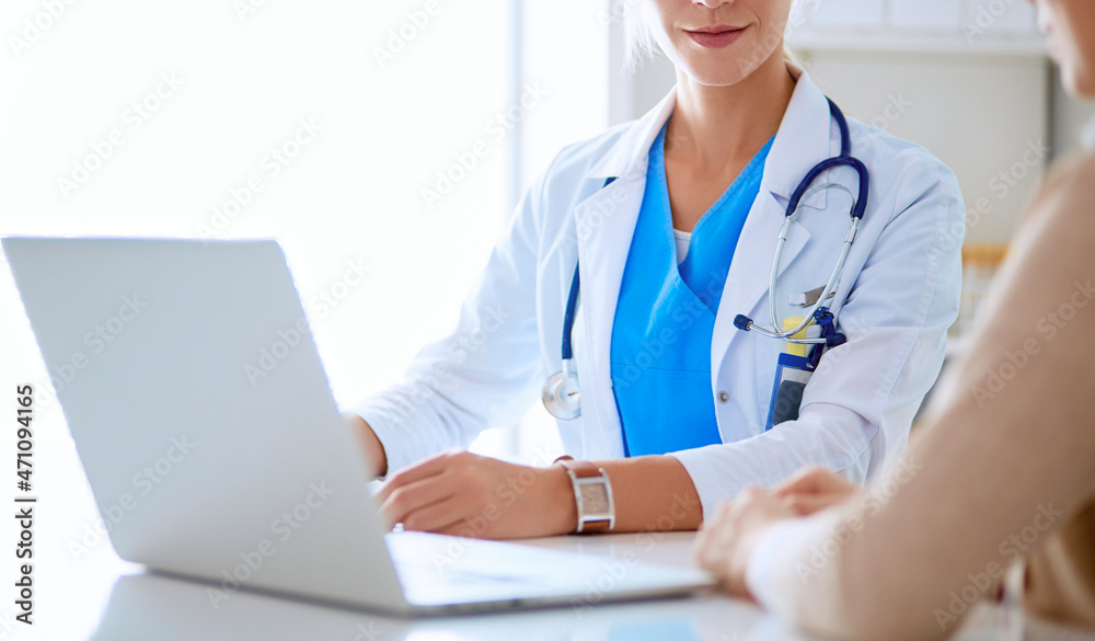 Doctor and patient couple are discussing something,sitting on the desk. Doctor and patient couple are discussing something,sitting on the desk.