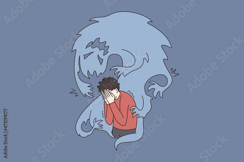 Inner fears and danger concept. Frustrated stressed boy standing covering face with hands and feeling afraid of ghost flying around vector illustration 