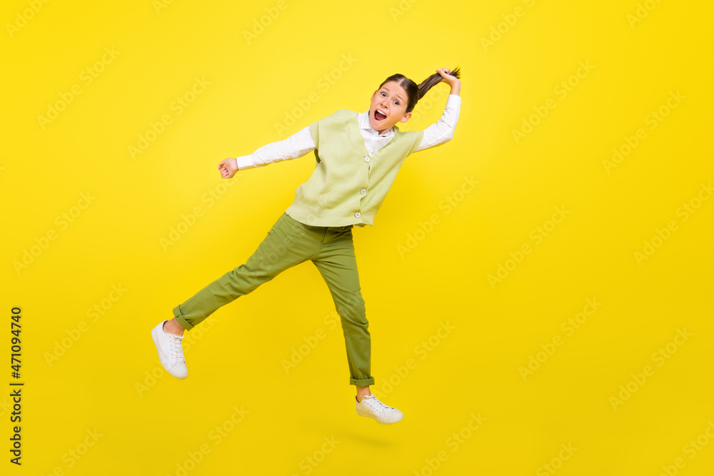 Full length body size view of attractive funny cheerful girl jumping making tail having fun isolated on bright yellow color background Full length body size view of attractive funny cheerful girl jumping making tail having fun isolated on bright yellow color background