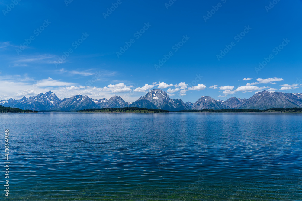 The blue waters of Jackson Lake on a sunny summer day in Grand Teton National Park near Jackson Hole, Wyoming