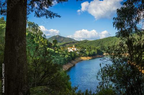 Picturesque village of Dornes in the Zezere river - Portugal. Old church and castle over the river with mountain background