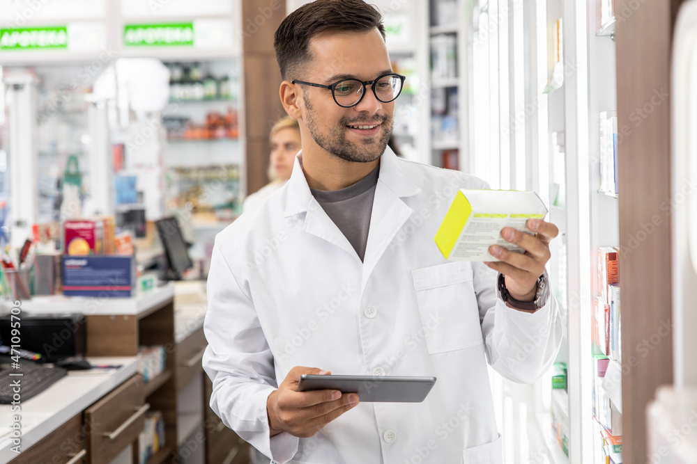 Male pharmacist working in a pharmacy.
Male pharmacist working in a pharmacy.
