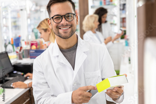 Portrait of male pharmacist in drugstore. photo