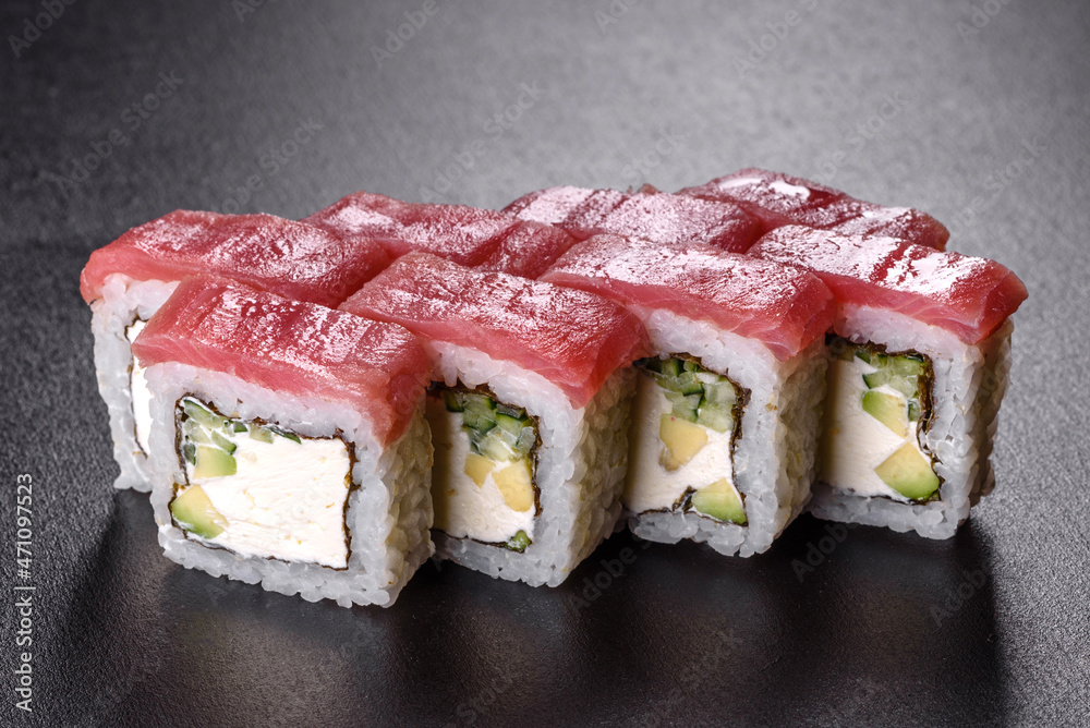 Traditional delicious fresh sushi roll set on a black background Traditional delicious fresh sushi roll set on a black background