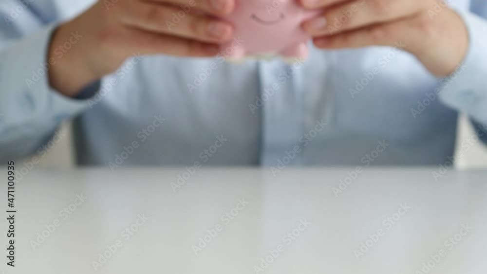 Businesswoman hands holding one us dollar and money box on a white table background Businesswoman hands holding one us dollar and money box on a white table background