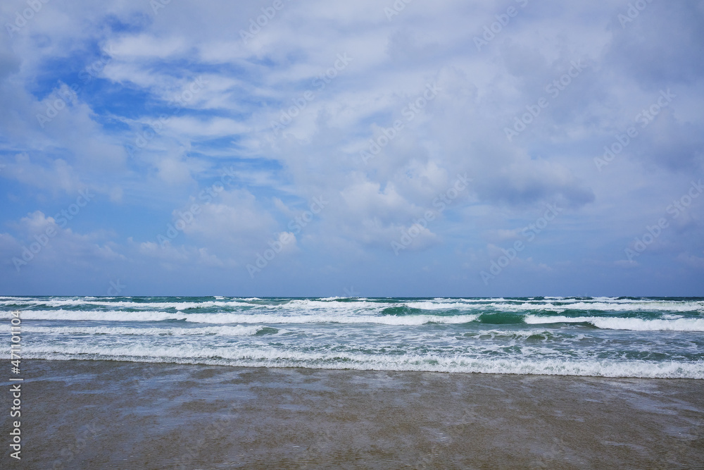 Sea coast with waves and sky with clouds. Storm at sea. Bad weather.