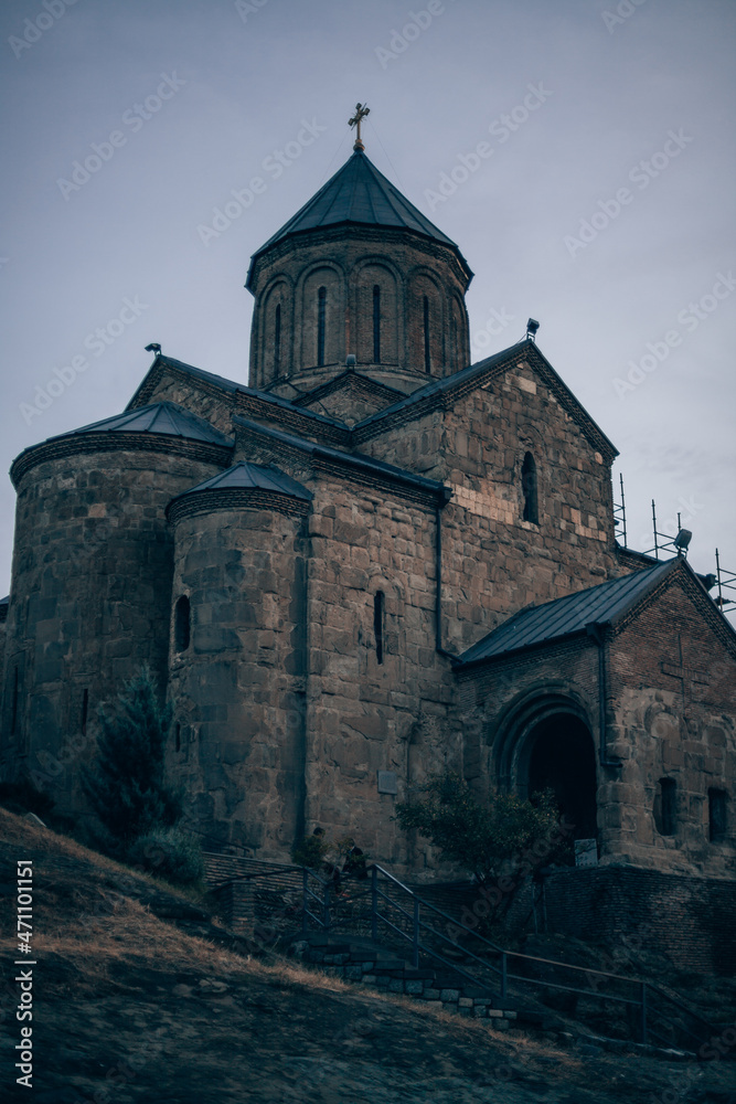 Ancient stone monastery in Georgia. Ancient church of dark stone on the hill. Old architecture, historical heritage