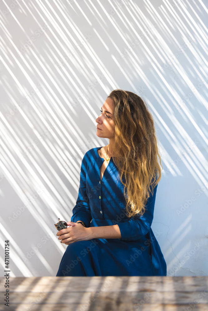 Fototapeta premium A young blonde girl enjoying sunshine in Capri island, Campania, Italy