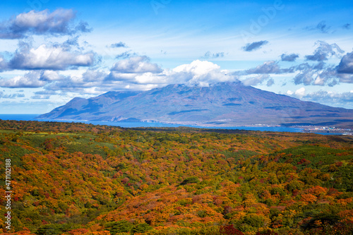 Iturup, Bogdan Khmelnitsky volcano against the background of an autumn forest. Kurile Islands