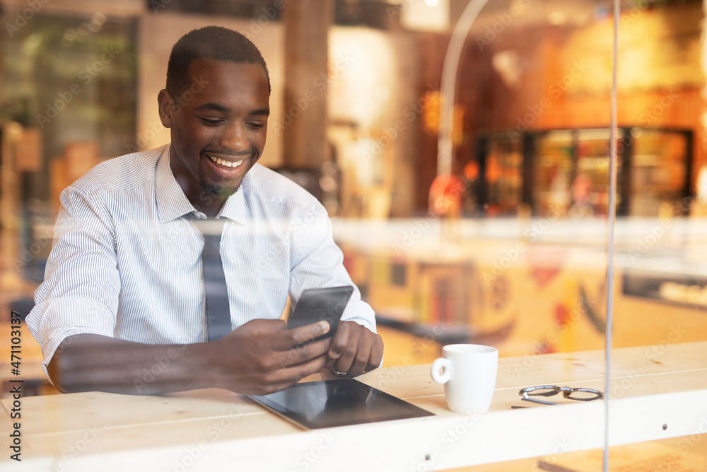 Businessman drinking coffee in cafe. Handsome African man enjoying in fresh coffee. Businessman drinking coffee in cafe. Handsome African man enjoying in fresh coffee.