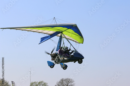 Fototapeta Naklejka Na Ścianę i Meble -  Ultralight airplane flying in a blue sky	