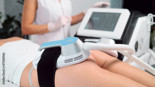 Video of close-up of woman lying receiving epilation laser treatment and anticellulite massage on buttock on the spa center. photo