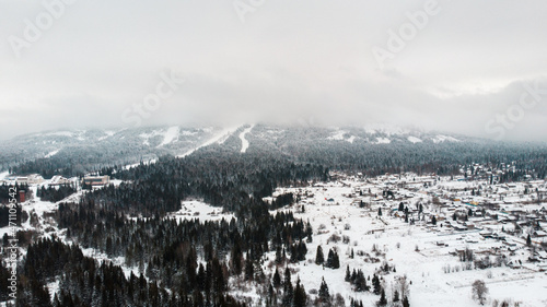 View from the height of the winter nature of the Russian village in the Ural mountains.