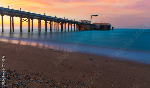 Pier leaving the sea at sunset