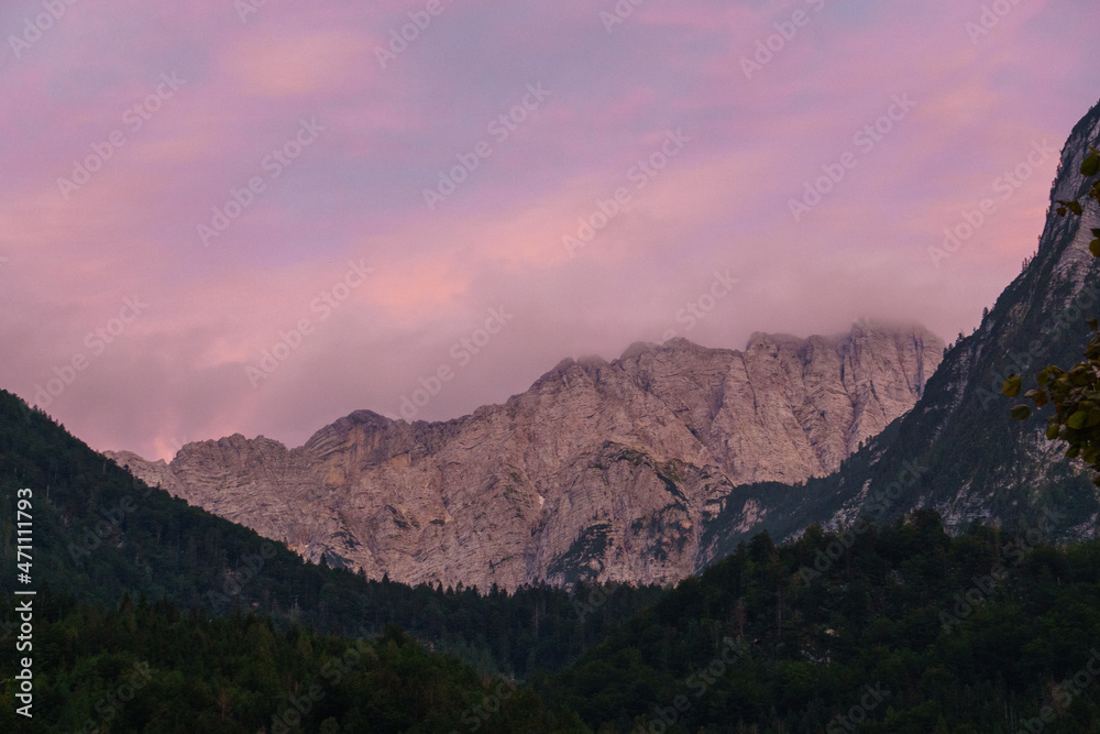 Red sunlight in the evening falling on rock formation of mountain in Julian Alps Triglav National Park, Slovenia
