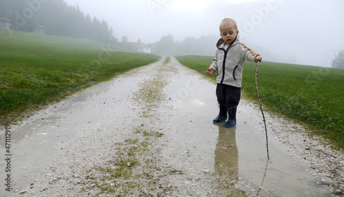 Baby play with water in a cloudy day