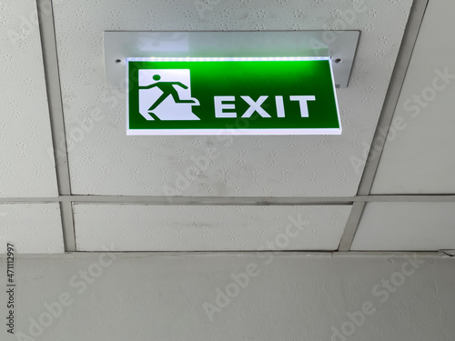 The green fire exit symbol on the ceiling.