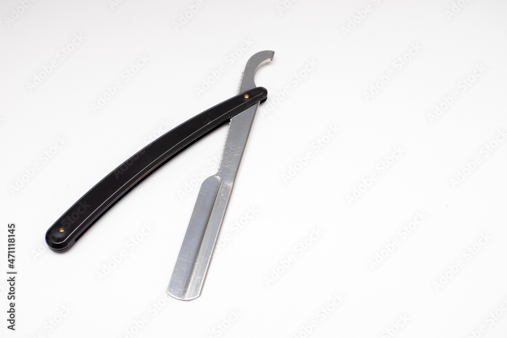 Black straight razor on a white background Black straight razor on a white background