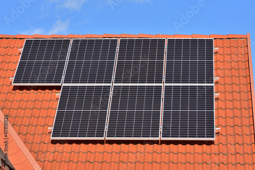 Solar panels on the house roof and against the wall wall on a sunny day. Summer. © W Korczewski