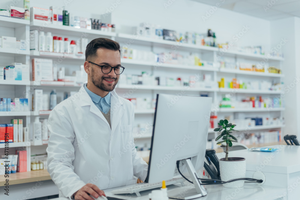 Portrait of a handsome pharmacist working in a pharmacy Portrait of a handsome pharmacist working in a pharmacy
