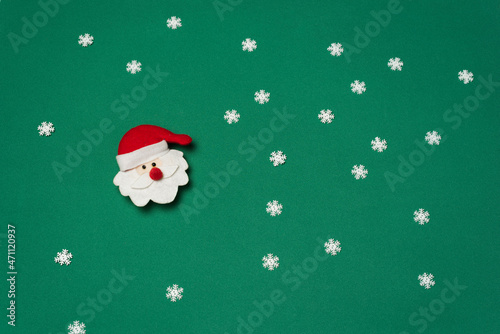 Santa claus on green background with snow crystals