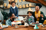 Happy African American family enjoys in Birthday party at home.