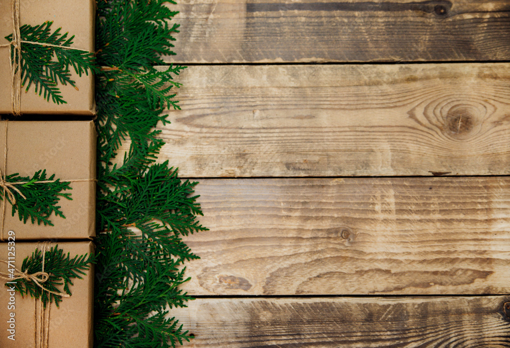 Boxes packed with kraft paper and natural twine on a wooden background.The concept of Christmas and New Year. Boxes packed with kraft paper and natural twine on a wooden background.The concept of Christmas and New Year.