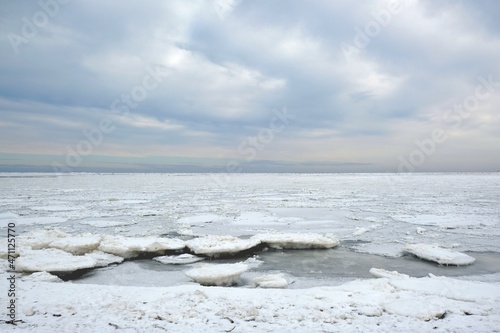 Winter seaside landscape - beach and frozen Baltic Sea near Mikoszewo, Zulawy Wislane, Poland photo