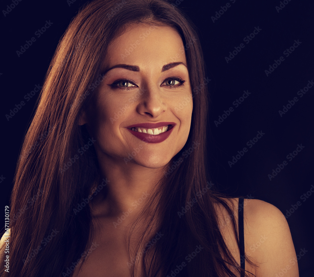 Beautiful makeup woman with long hair looking happy on black background. Closeup portrait Beautiful makeup woman with long hair looking happy on black background. Closeup portrait